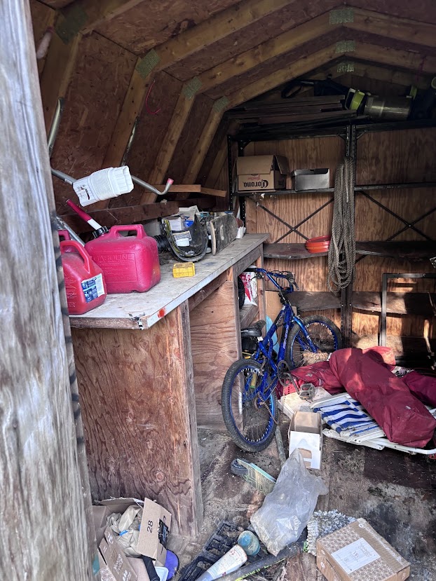 Backyard shed full of junk before cleanout